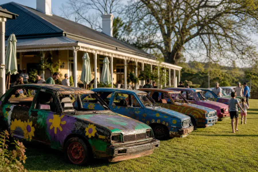 Hand-painted old cars on the lawn of a country hotel